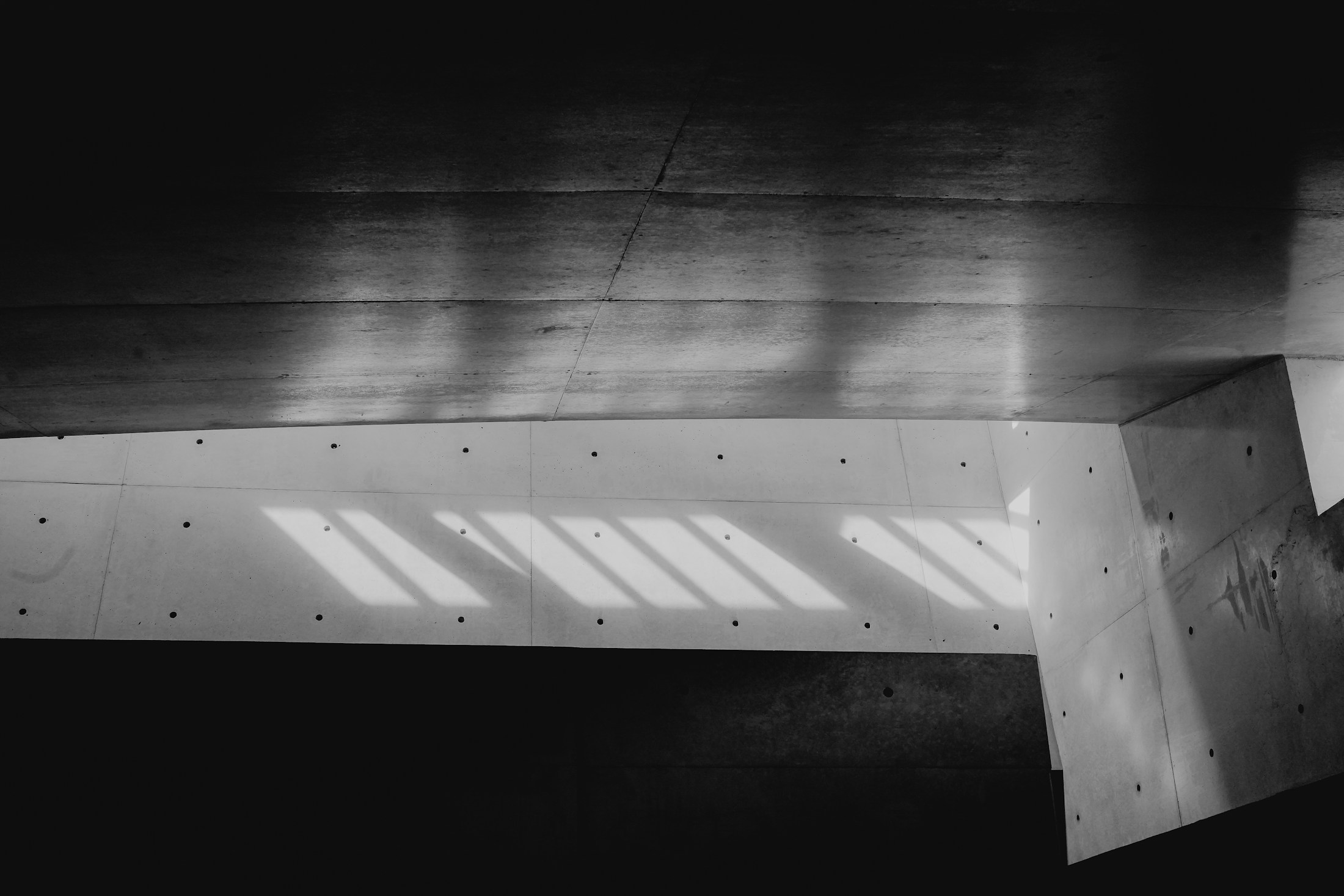 Natural light turns a concrete interior into a precise graphic field.